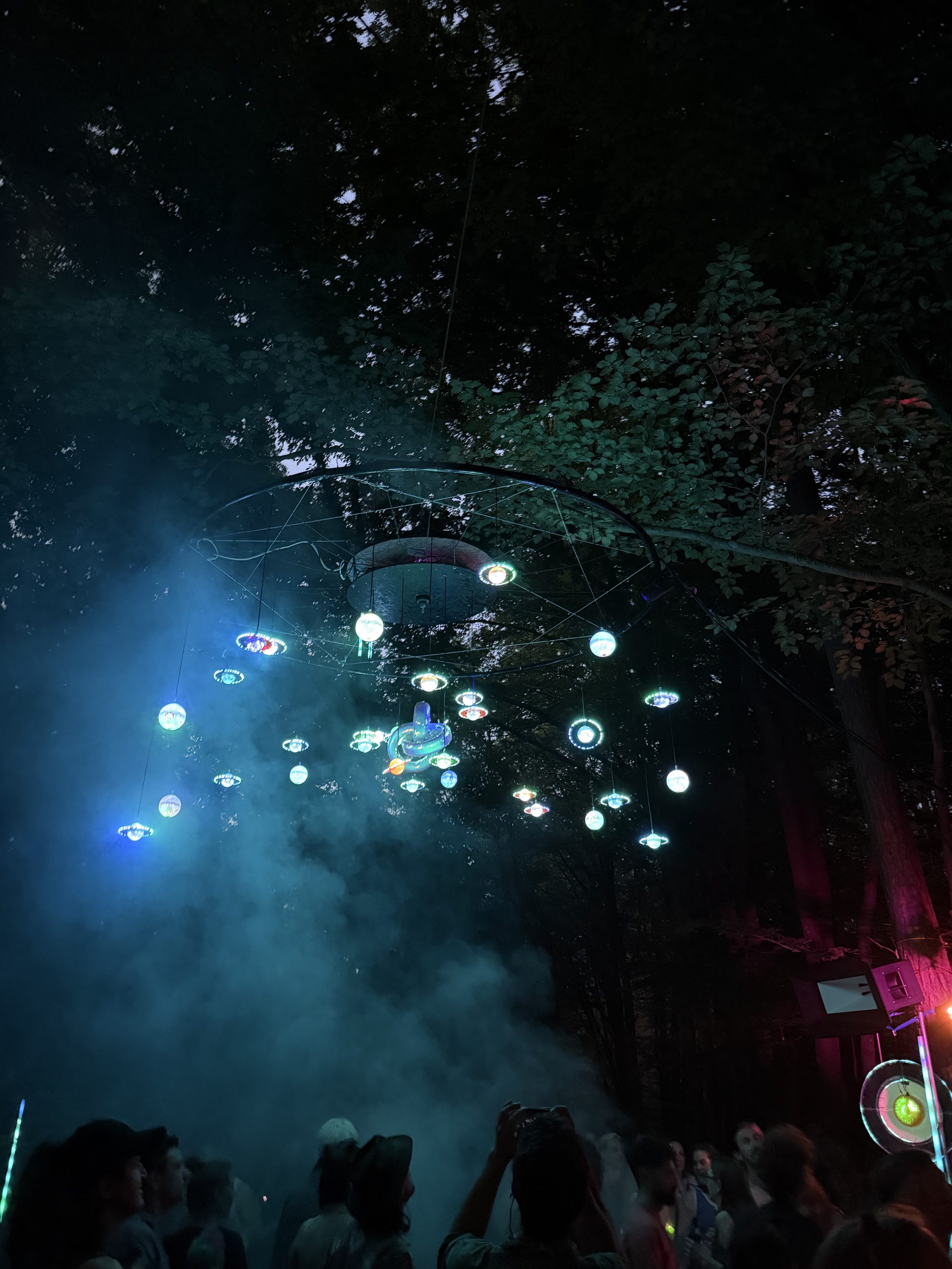 Cosmic Sinkhole: schwebende LED-Planeten im Nebel über dem Publikum im Wald
